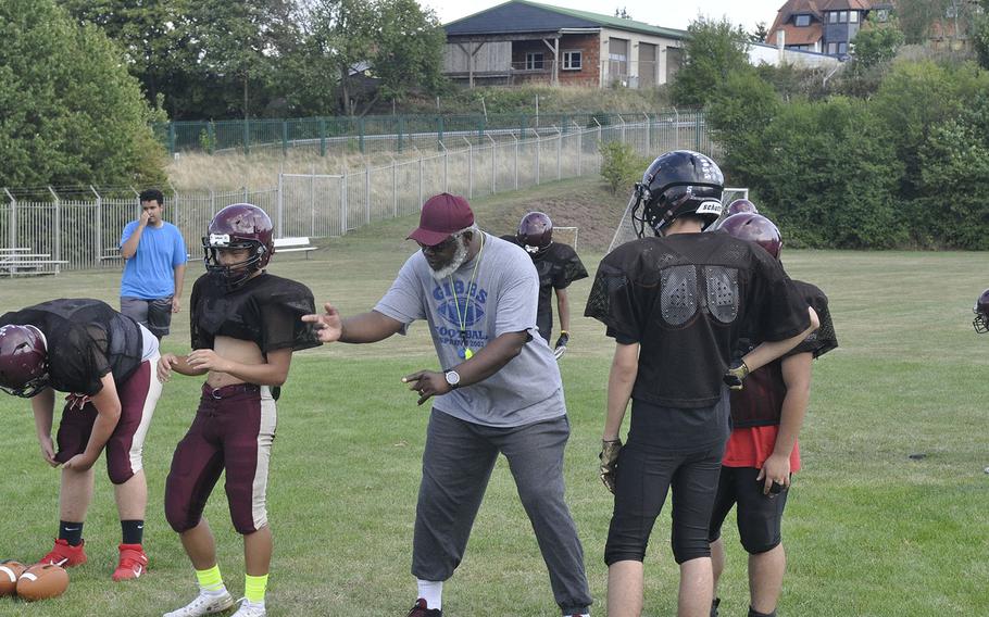 Head coach Phillip Loyd instructs Baumholder Bucs players during a preseason football practice Wednesday, Aug. 28, 2019, at Baumholder, Germany. The Bucs have a full preseason to prepare for their six-man league after a late arrival to the division last summer.