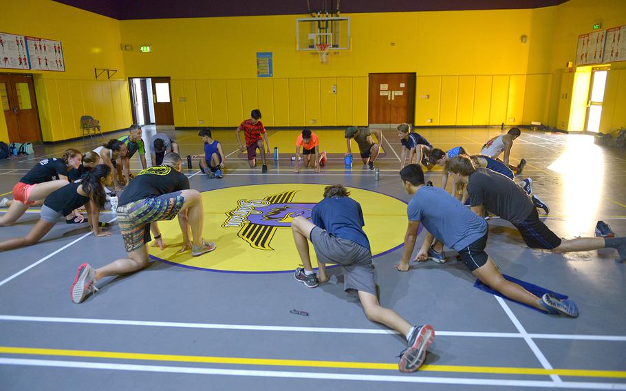 Athletes conduct stretching exercises in Bahrain on Thursday, Oct. 3, 2019. The team trains early in the morning inside the school's hallways to avoid heat-related injuries. 