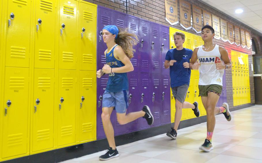 Athletes run laps around the hallways of the DODEA-Europe school in Bahrain on Thursday, Oct. 3, 2019. The team trains before school in the hallways to avoid heat-related injuries. 
