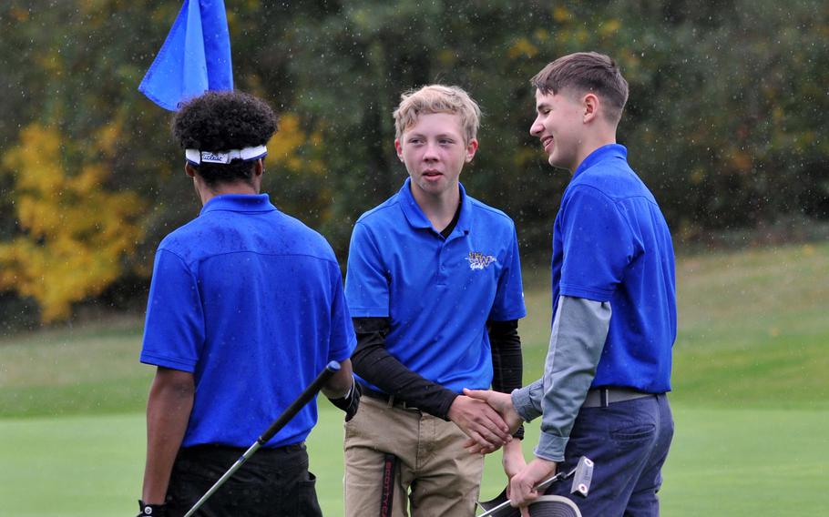 Ramstein's Ben Todman, left, and Micah Webb, right, congratulate Wiesbaden's Clayton Shenk after the freshman captured the 2019 boys DODEA-Europe golf title at Wiesbaden, Thursday, Oct. 10, 2019.










