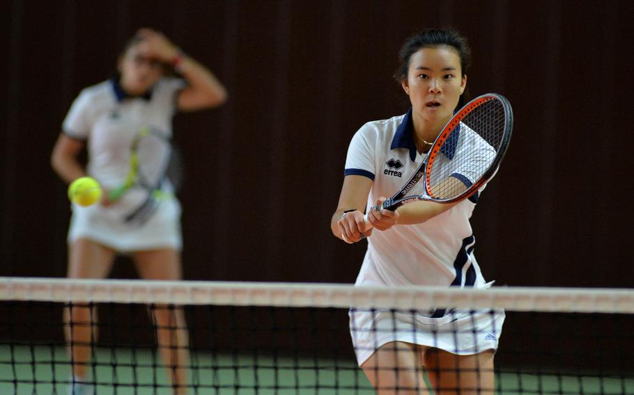 Marymount's Eri Ishii slams the ball over the net in a girls doubles match against Ramstein at the DODEA-Europe tennis championships in Wiesbaden, Germany, Thursday, Oct. 24, 2019. Ramstein won an emotional match 7-5, 4-6, 10-5. Watching in the background is Ishii's teammate, Francesca Buonpensiere. 










