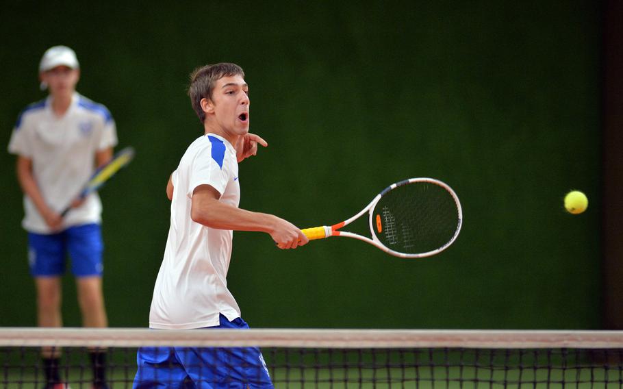 Ramstein's Troy Boehne returns a Florence shot over the net as teammate Colin Kent watches in the background in a boys doubles match at the DODEA-Europe tennis championships in Wiesbaden, Germany, Thursday, Oct. 24, 2019.  