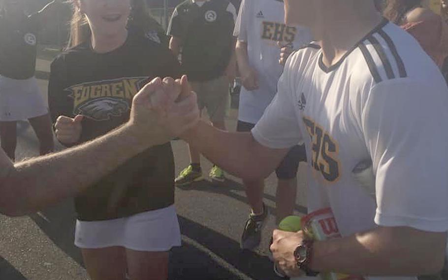 Robert D. Edgren junior Ryken Calleros gets congratulated by teammates after his upset victory in the Far East tennis singles quarterfinals.