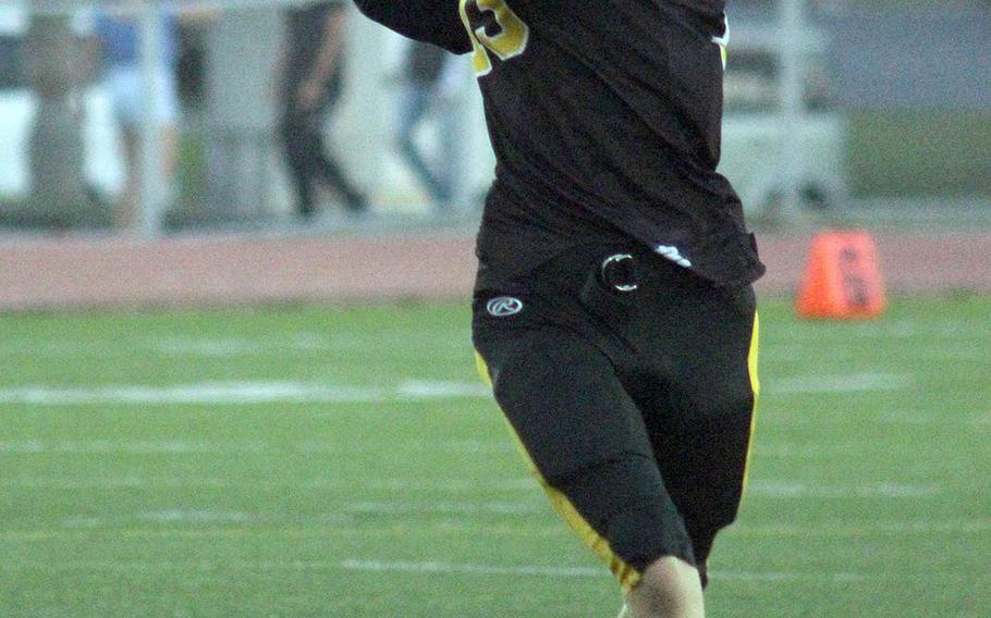 Kadena quarterback Jack Carey looks to throw on the run.