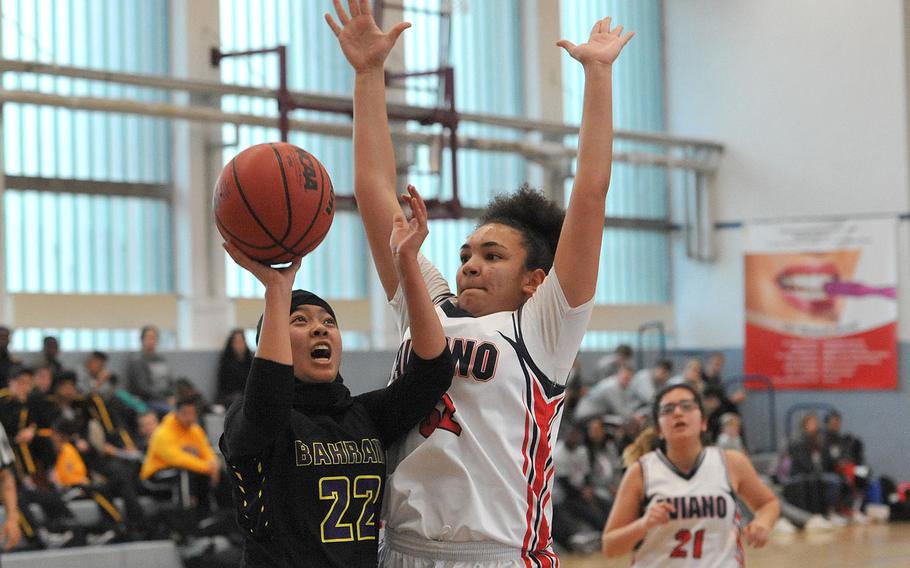 Bahrain's Tasneem Abdkhair shoots against Aviano's Keyona Williams in a Division II game at the DODEA-Europe championships last season.