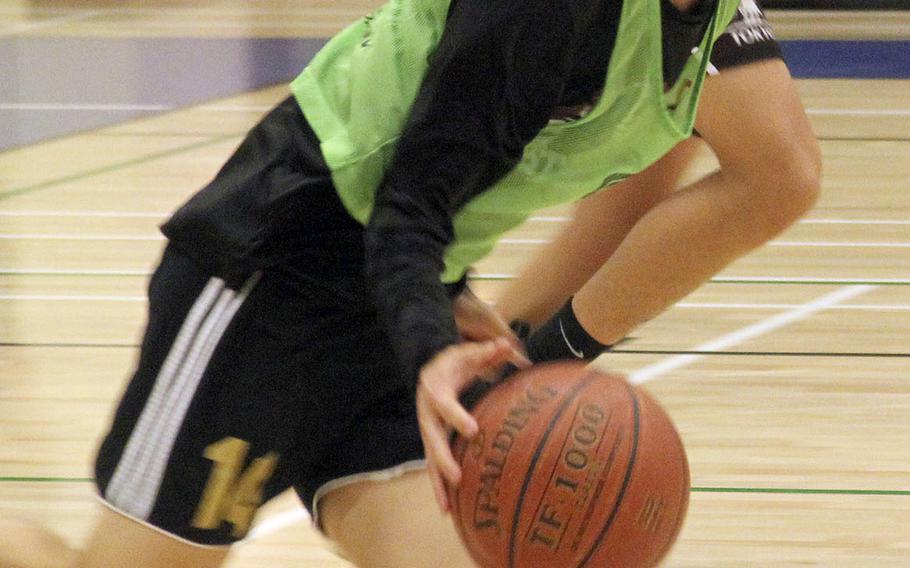 Yokota senior guard David Carlson dribbles the ball upcourt during practice.