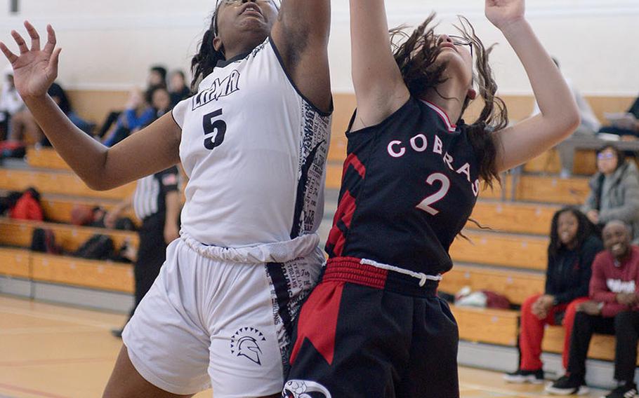 Zaman's Jalina Colar and E.J. King's Aileen Fitzgerald leap for a rebound.