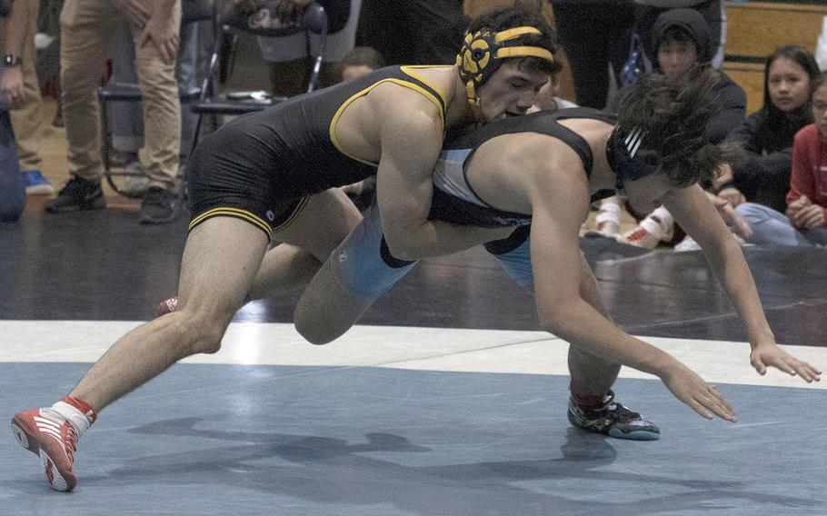 ASIJ's Rin Zoot, the reigning Far East Outstanding Wrestler, takes down Osan's Ramil Celones en route to a 10-0 technical-fall victory in Thursday's semifinal.