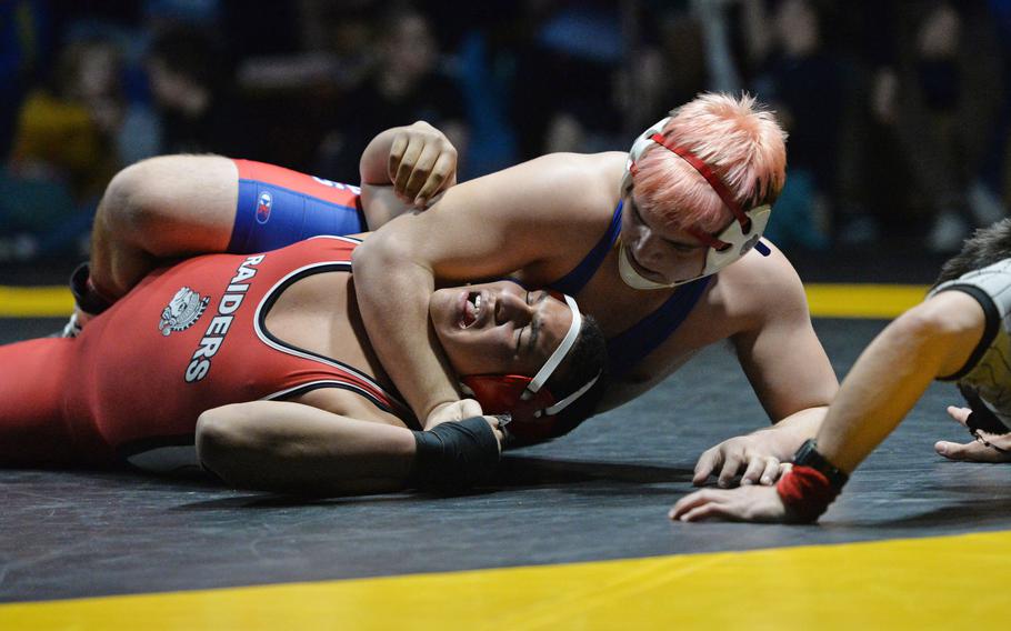 Ramstein's Gabriele Davis puts the pressure on Kaiserslautern's Christopher Monroe in the 220-pound championship match at the DODEA-Europe wrestling finals in Wiesbaden. Germany, Saturday, Feb. 15, 2020. Davis defeated Monroe for the title.