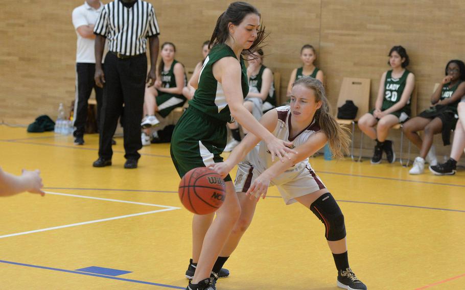 AFNORTH's Katelyn Eidson passes to a teammate as she is defended by Ankara's Milla Brown  in a Division III game at the DODEA-Europe basketball championships in Wiesbaden, Germany, Wednesday, Feb. 19, 2020. AFNORTH won 48-9.