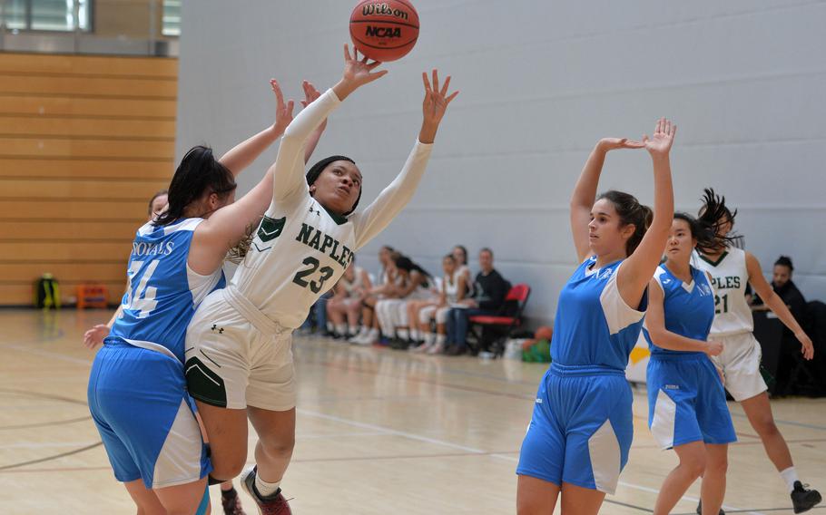 Naples' Dasia Greely scores an off-balance basket against Marymount's Anna Aboltina in a Division II game at the DODEA-Europe basketball championships in Wiesbaden, Germany, Wednesday, Feb. 19, 2020. Naples won 48-13.