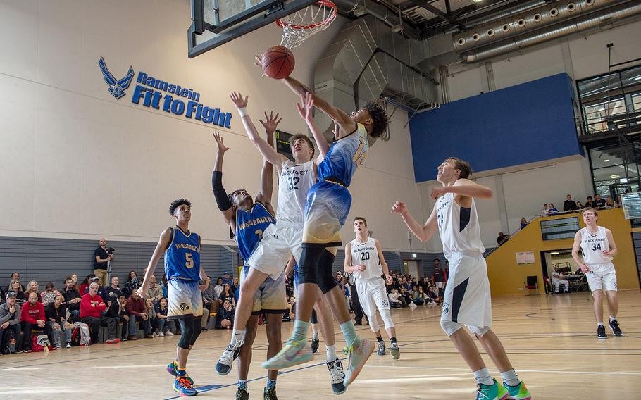 Players form Weisbaden and Black Forest Academy go up for a rebound during the DODEA-Europe 2020 Division I basketball playoffs at the Southside gym on Ramstein Air Base, Germany, Wednesday, Feb. 19, 2020. 