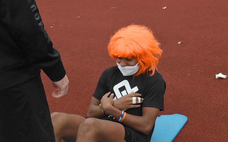 Vilseck's Aveion Ruffin, center, conducts sit-ups while showing off his Halloween spirit during the European Athletic Fitness Games championships at Vilseck, Germany on Saturday, Oct. 31, 2020.