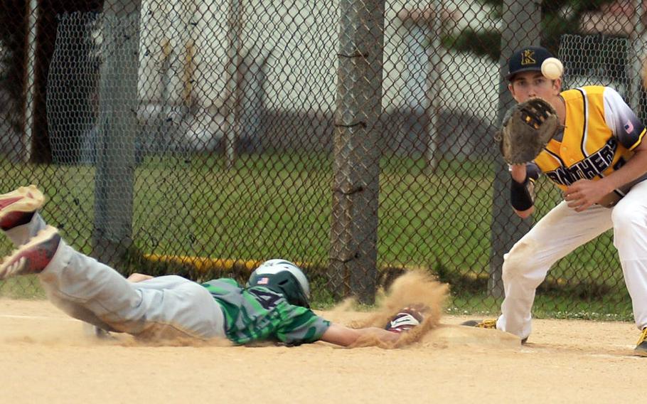 Kubasaki's Andrew Welte dives back into first base ahead of the pickoff throw to Kadena's Wyatt Boerigter during Thursday's Okinawa baseball game. The Panthers won 10-6.
