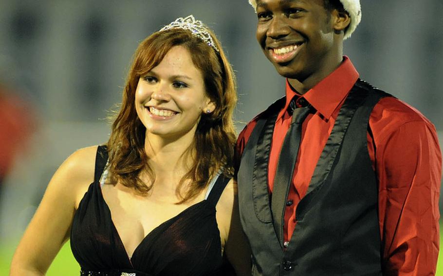 Tre Simmons and Krystal Hartke pose for photographers after they were crowned Mannheim High School's final Homecoming king and queen during the halftime intermission of the homecoming game against Bitburg on Friday night. The school is scheduled to close at the end of the school year.