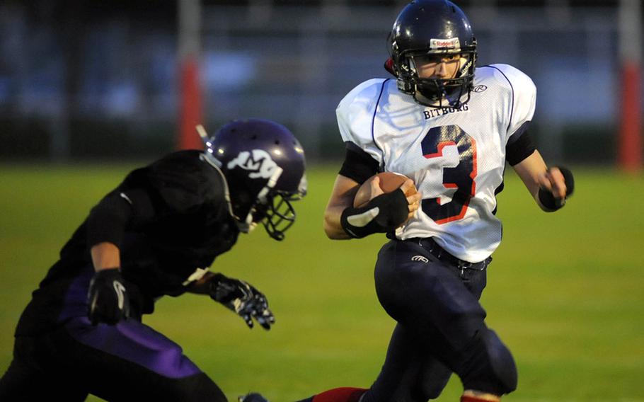 Mannheim's Calvin Baisden, left, closes in on Bitburg's Aaron Mayfield after Mayfield rushed for a big gain in the Barons' 21-6 win over over Mannheim Friday night.