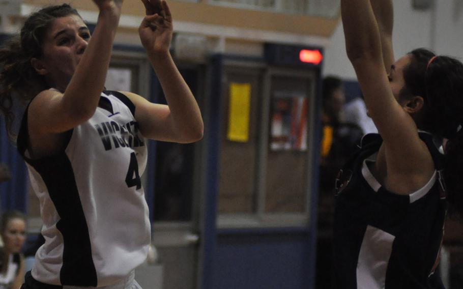 Vicenza's Lali Baratashvili shoots over Aviano's AnnMarie McCllelland on Friday during the Cougars' 47-43 victory over the Saints that left the two teams just a game apart in the American Schools in Italy standings with one game to play. Baratashvili finished with a game-high 28 points.