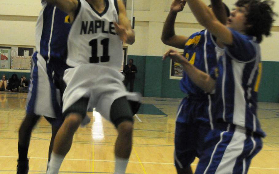 Naples junior point guard Jun Jun Gallardo tries to score against a host of Sigonella defenders during the Wildcats' 72-39 victory Friday.