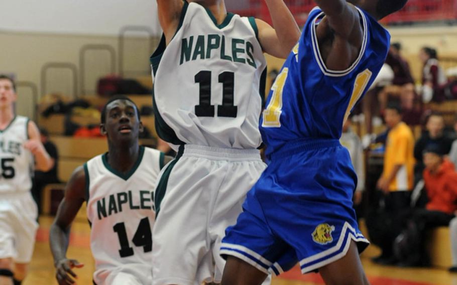 Jun Jun Galardo of Naples shoots over the defense of Ansbach's LJ Finley as the top-seeded Wildcats beat Ansbach, 44-34, in opening day Division II action at the DODDS Europe basketball championships in Mannheim, Germany.