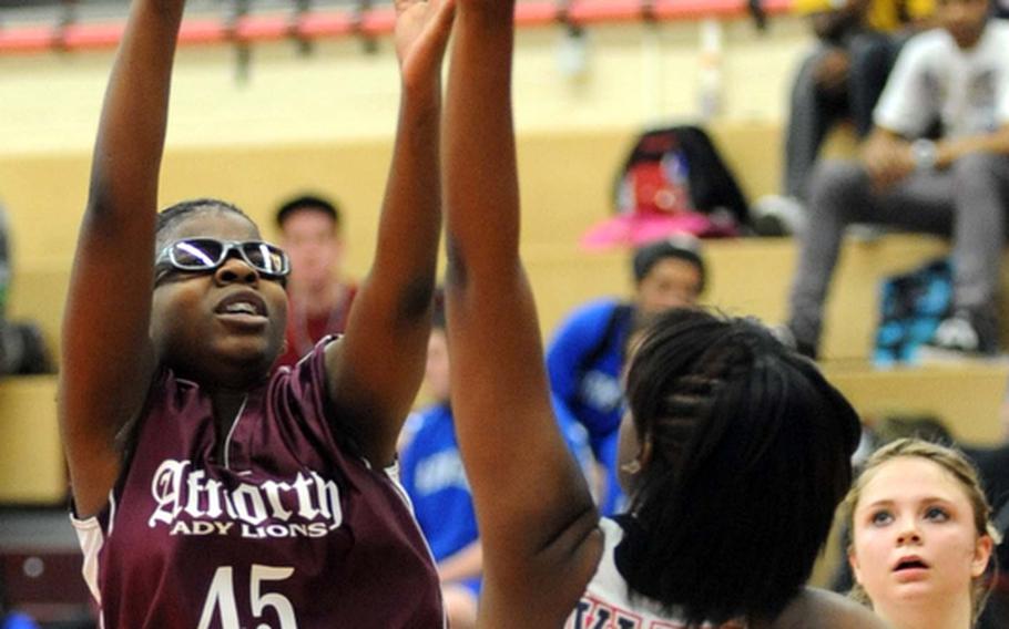 AFNORTH's Monique Miller, left, shoots over Aviano's Kyerha Smith in AFNORTH's 36-17 quarterfinal loss to the Lady Saints on Friday. Top-seeded Aviano moved on to the semifinals later in the day.