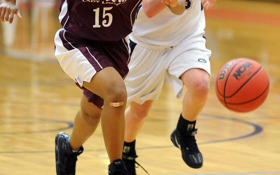 AFNORTH's Nyekiah Deshazor, left, and Aviano's Casey Brunetti chase down a loose ball in their Division II quarterfinal at the DODDS Europe basketball championships. Aviano won, 36-17, to reach the semifinals later in the day.