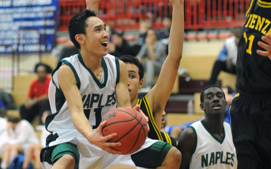 Jun Jun Gallardo of Naples sails towards the basket Friday against Vicenza defenders Derrick Schaefer and Mike Weston. Naples won the Division II quarterfinal game, 69-57.