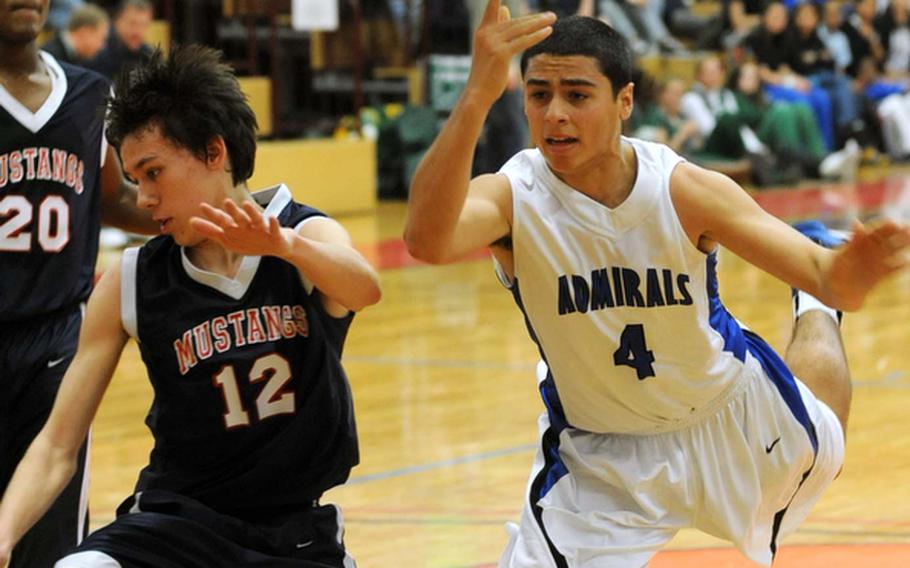 Menwith Hill's Ryan Reers, left, and Sergio Rivera of Rota collide during their Division III semifinal on Friday. Rivera was called for an offensive foul. Rota won the game, 68-29, to advance to Saturday's Division III title game.