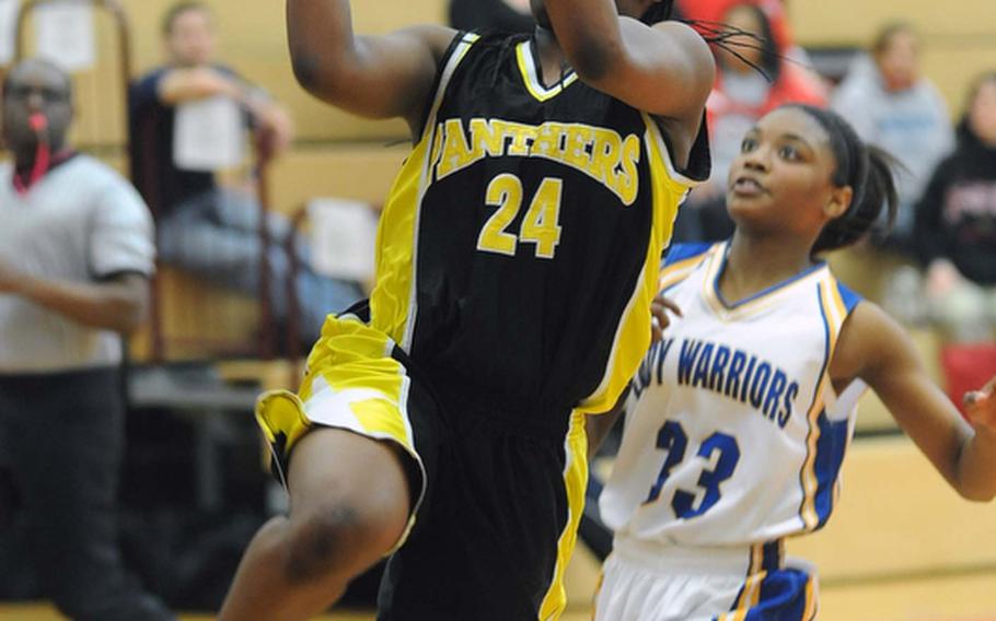 Patch's Nelley Loney, left, eyes the basket after getting past Wiesbaden defender Kelley Colbert, as second seeded Patch defeated defending Division I champ and top seed Wiesbaden, 41-31. Loney scored 30 points in the win.