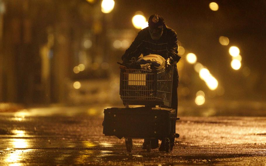 Lenard Sanders, a homeless man, pushes his cart toward a subway station to seek shelter as Hurricane Irene makes its way along the Eastern Seaboard, Sunday in Philadelphia. The National Hurricane Center says a hurricane warning remains in effect from coastal Virginia northward to Sagamore Beach, Mass. 