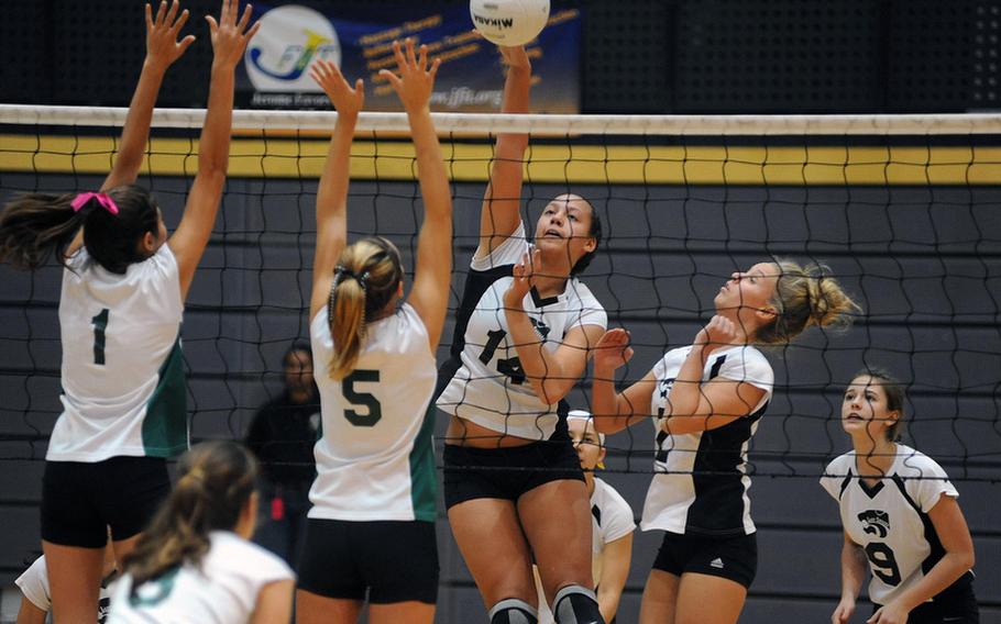 Vicenza's Danielle Ellis slams the ball across the net against the block of Victoria Krause, left, and Gee Trigg in a Division II semifinal at  the DODDS-Europe volleyball finals in Ramstein, on Friday. From right are Vicenza's  Natalie Lovelace and Sella Pauling, in the foreground is Katie Waller of Naples.