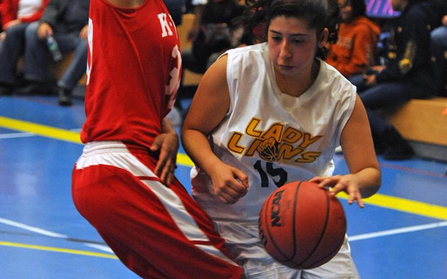Heidelberg's Rebecca Luna drives against Jada Perry of Kaiserslautern in the Lady Lions' 38-36 win over the visiting Raiders on opening day of the 2011-12 DODDS-Europe basketball season Friday night.