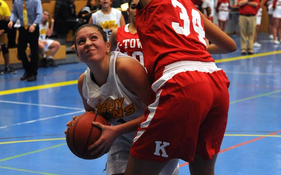 Heidelberg's Aileen Donnelly, left, looks to get off a shot against  Kaiserslautern's Angela Powell in Heidelberg's 38-36 win over the Raiders on opening day of the 2011-12 DODDS-Europe basketball season in Heidelberg, Friday night.