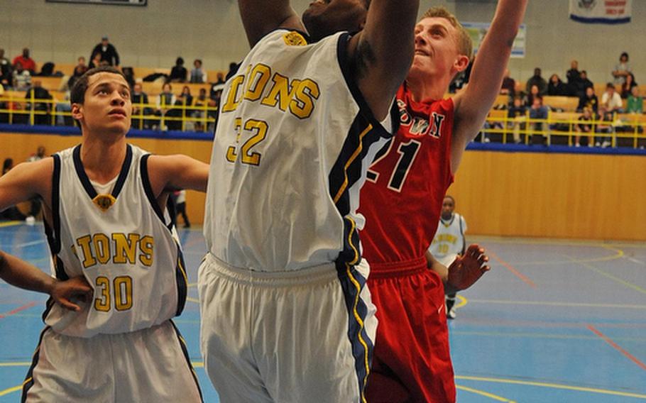 Heidelberg's Mezzan El Sayed gets past Kaiserslautern's Andrew Stern as teammate Marcel SImon watches in opening day action of the 2011-12 DODDS-Europe basketball season in Heidelberg on Friday night.
