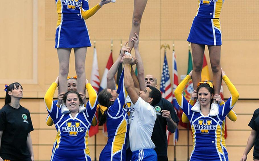 The Wiesbaden Warriors cheer team build a pyramid during their routine at the DODDS-Europe cheerleading championships.