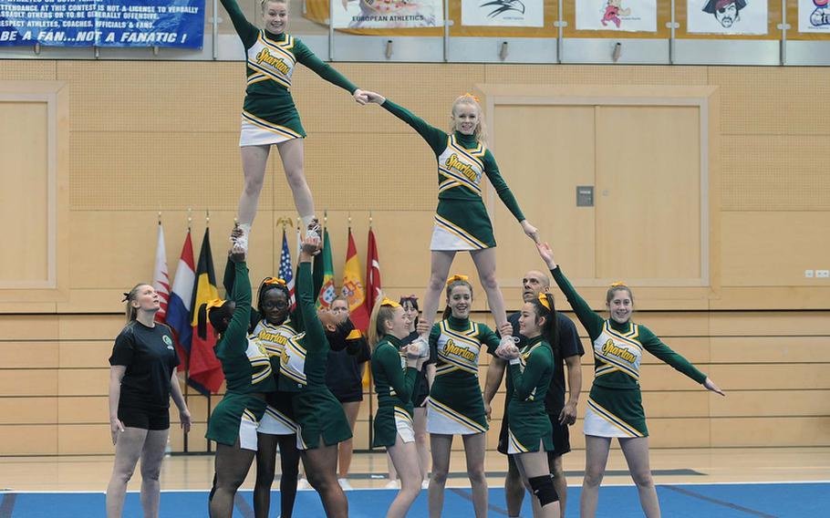 The SHAPE Spartans cheer team build a pyramid at the DODDS-Europe cheerleading championships.
