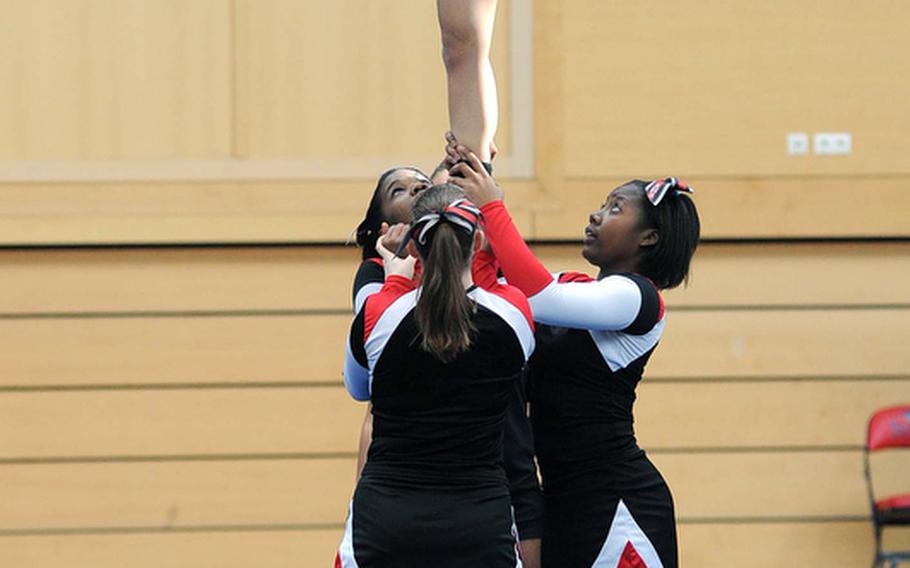 The Schweinfurt Razorbacks cheer squad, participating for the first time at the DODDS-Europe cheerleading championships, perform a stunt during their routine.