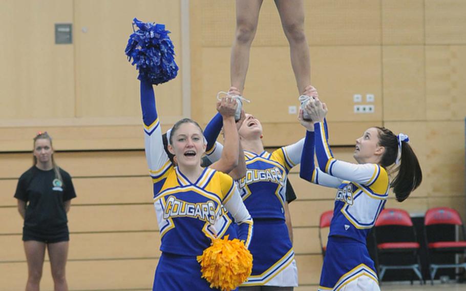 The Ansbach Cougars cheer team perform a stunt during their routine at the DODDS-Europe cheerleading championships in Wiesbaden, Saturday. The Cougars took first place in Division II, ahead of AFNORTH and Aviano.