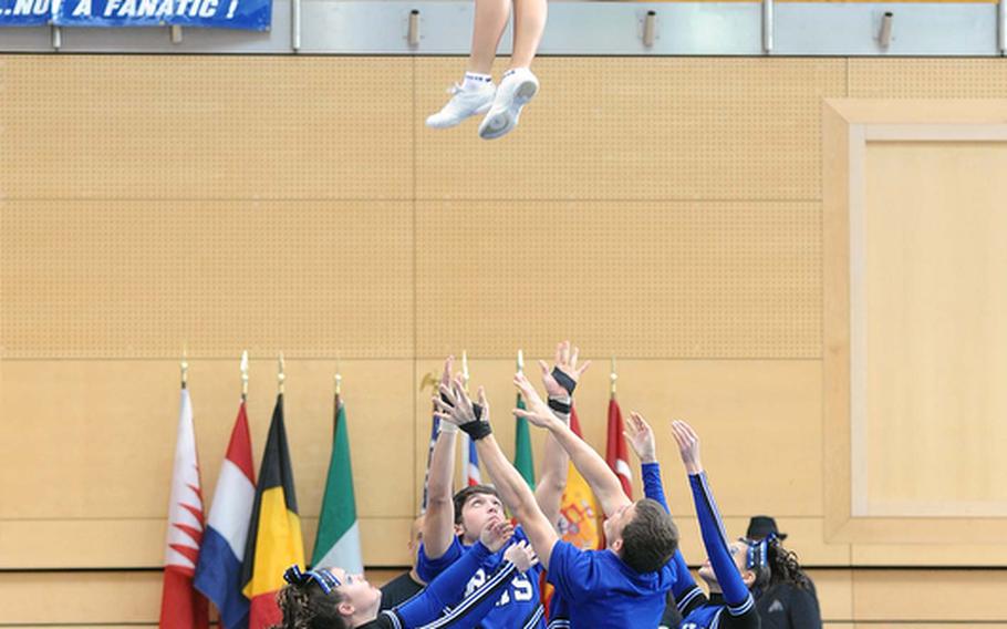 The Rota Admirals cheer squad sends a member flying high, as they perform a stunt at the DODDS-Europe cheerleading championships. The Admirals won their third straight Division III title following two in Division IV in 2008 and 2009.