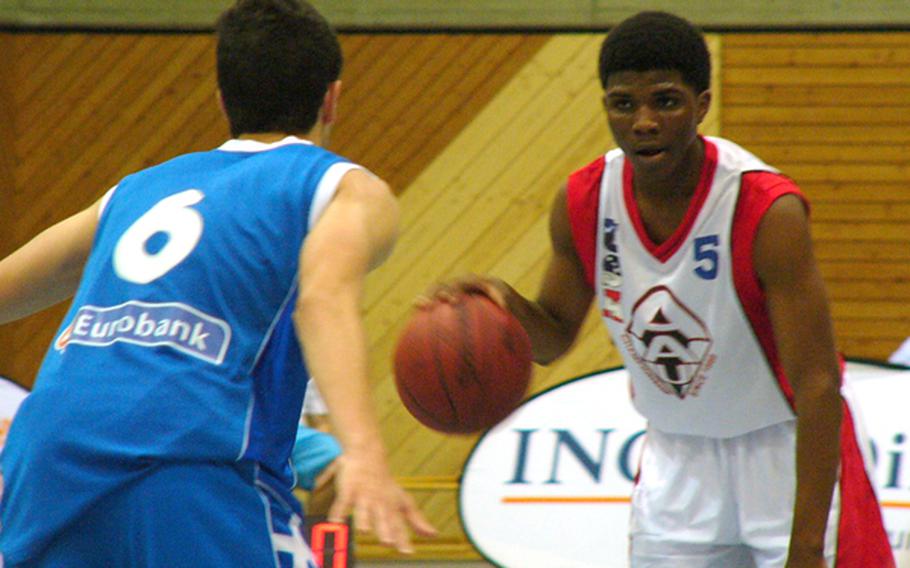 Stevie Clark of Oklahoma City prepares to take the ball to Greek defender Georgios Aggelou during the U.S. team's 76-63 opening-day victory in the 26th Albert Schweitzer Youth International basketball tournament at Viernheim. Germany.