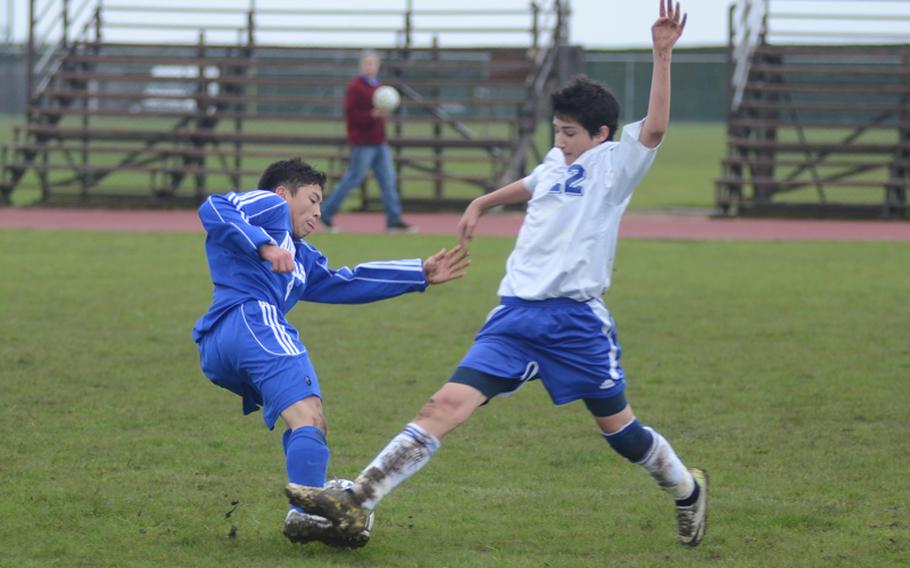 Rota's Kris Rios, left, and Brussels' Merab Chitanava stab at the soccer ball during a meeting Friday at RAF Alconbury, England. The Brigands won the match by a score of 2-0. Chitanava and Lazar Knezic were the goal scorers for Brussels.