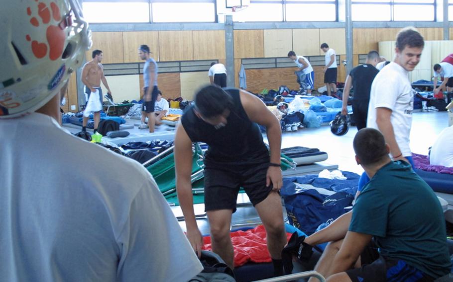 Campers settle into the Ansbach High School gym on Aug. 11, 2012, their home for the next three nights at the annual DODDS-Europe Football Camp. Bedrolls fill the gym and halls of the high school, home to the event since 2005.