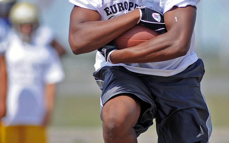 Vilseck's Carlton Campbell looks upfield as he goes through a running back drill at this year's DODDS European Football Camp at Ansbach, Germany.