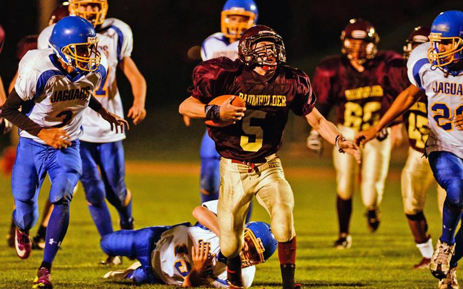 Baumholder's Ben Holliday runs down field Saturday night in Baumholder's 42-14 DODDS-Europe Division III victory over Sigonella.
