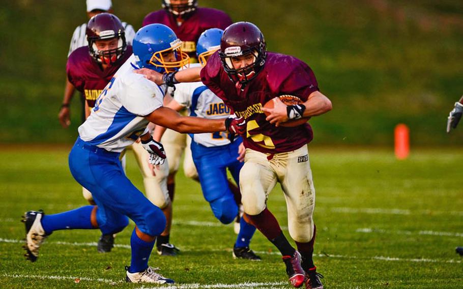 Baumholder's Ben Holliday stiff arms a Sigonella defender Saturday night in Baumholder's 42-14 DODDS-Europe Division III victory.