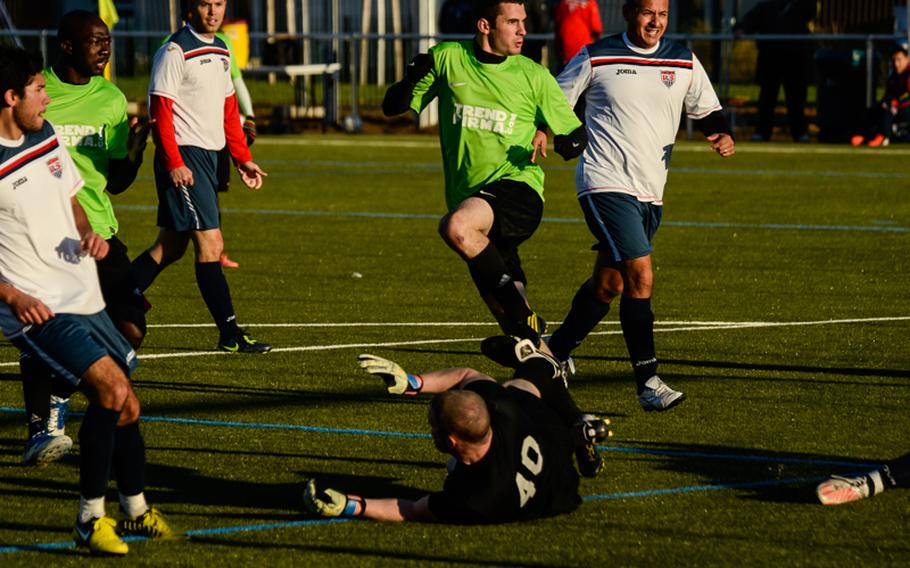 Ramstein's Joe Berry watches the ball roll into the net after kicking it past Vicenza's goalie, Shawn Durcan, for Ramstein's first goal Oct. 28, 2012, in the U.S. Forces Europe soccer championship in Wiesbaden, Germany