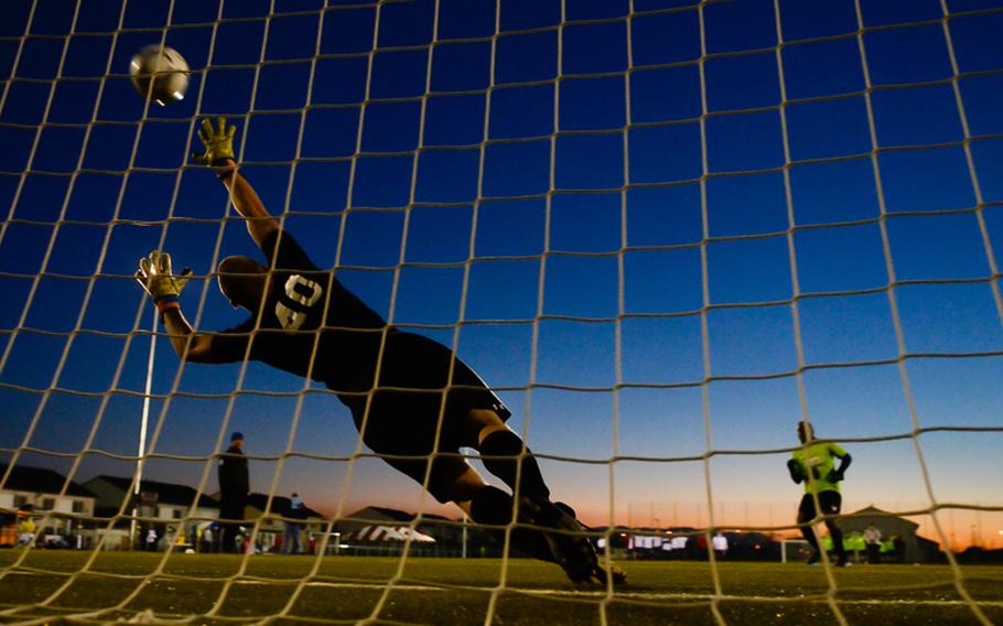 Ramstein's Leighton Holness scores the U.S. Forces Europe soccer championship's winning penalty kick past the reach of Vicenza's Shawn Durcan on Oct. 28, 2012, in Wiesbaden, Germany.