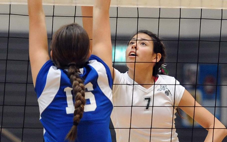 Victoria Krause of Naples goes against the defense of Natalie Taylor in a Division II match at the DODDS-Europe volleyball championships.  Naples won the match 25-12, 25-11.