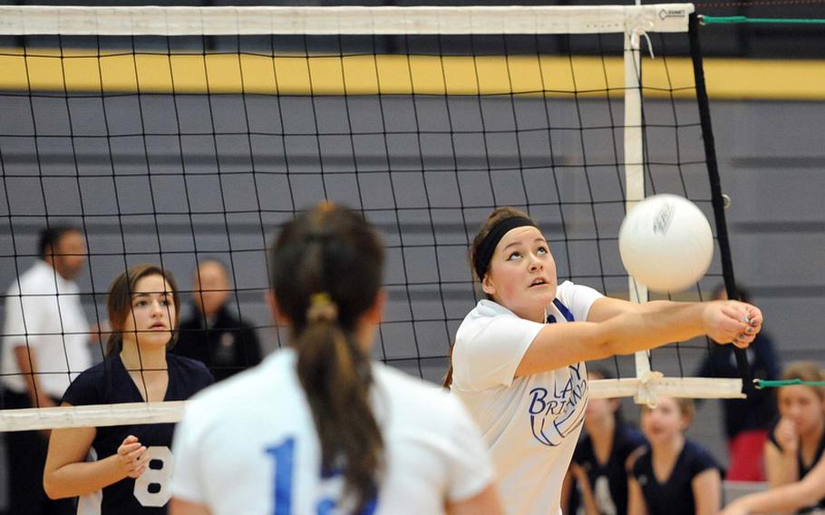 Teodora Vasileva of Brussels hits the ball in a Division III quarterfinal match at the DODDS-Europe volleyball championships as her sister Ana-Marija and Menwith Hill's Lindsay Wooleyhand watches.  Menwith Hill won 25-18, 22-25, 25-19 to advance to the semifinals against top-seeded Rota.