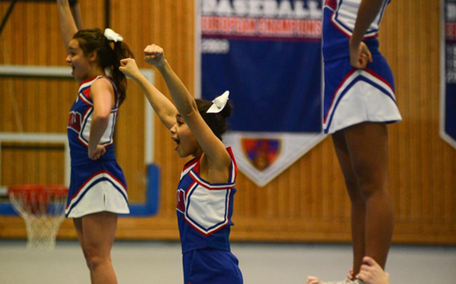 Ramstein High School's cheerleaders perform a routine Friday night during halftime of the girls game against Vilseck High School.