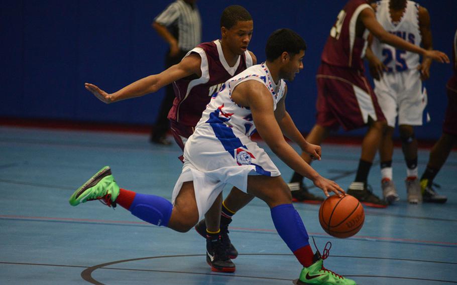 Ramstein High School's Will Dorsey brings the ball across half court Friday night at Ramstein Air Base as his team defeated Vilseck High School.